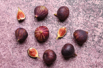 Fresh ripe figs on purple background