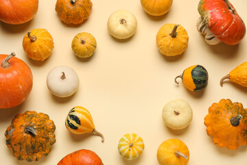 Frame made of different fresh pumpkins on yellow background