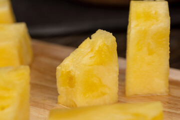 ripe pineapple of yellow-orange color cut into pieces