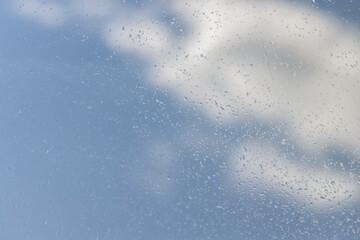 Obraz premium glass covered with rain water drops in a building window