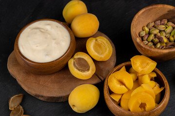 fresh yogurt with taste and chunks of yellow apricot