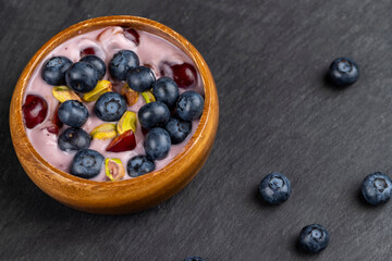 fresh blueberry-flavored yogurt with ripe blueberries and pistachios