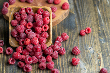 Ripe raspberries on a wooden board