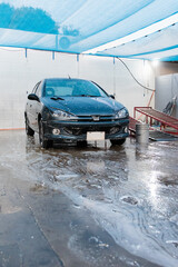 Car full of foam parked in the car washer.