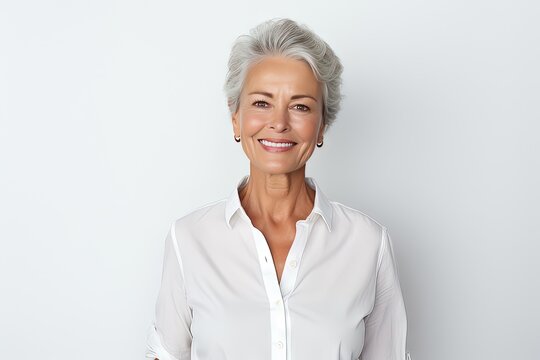 Smiling Friendly And Happy Older White Woman (female Model) Posing Against A Studio Background