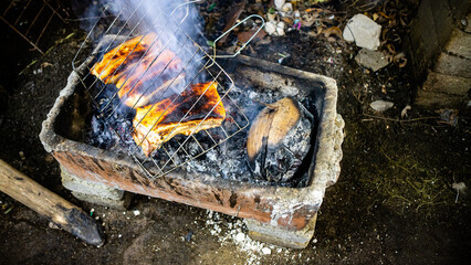 Pork being grilled on a traditional grill
