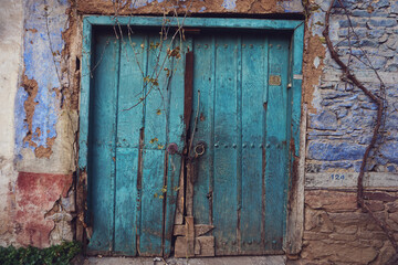 Fototapeta na wymiar Old, colorful wooden door with lock - fairytale door to a world of fantasy
