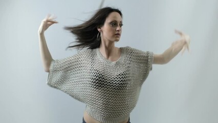 Urban and attractive girl dancing freestyle on white background
