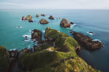 Large rocks on the coast surrounded by blue water
