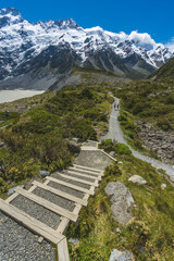 Hikers walking on a sunny day along a mountain trail 