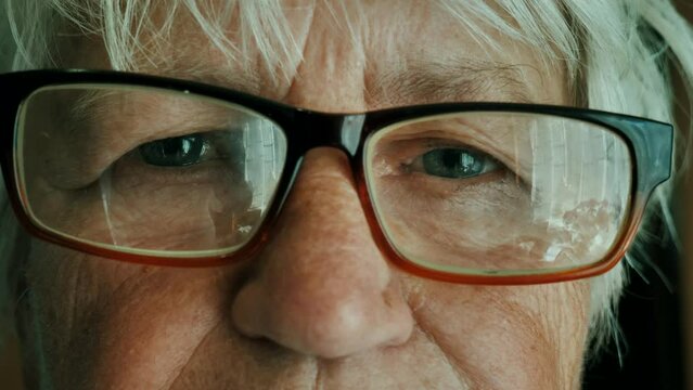 Opening eyes, Face and eyes of an old woman with glasses. close-up face. portrait of an elderly woman with glasses.