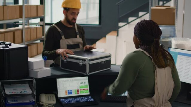 Storage center warehouse manager carrying out the logistics of receiving, processing, storing and sending inventory according to purchase orders and shipping schedules, helped by adept assistant
