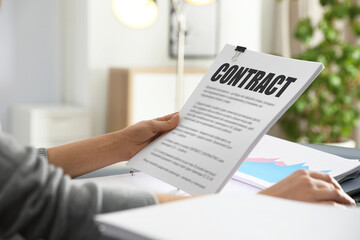 Government contract. Woman reading document at table, closeup