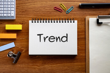 There is notebook with the word Trend. It is as an eye-catching image.