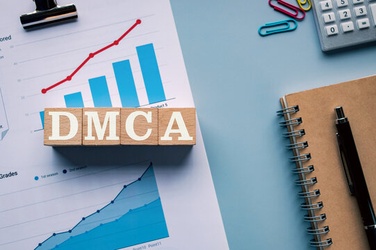 There is wood cube with the word DMCA. It is an abbreviation for Digital Millenium Copyright Act as eye-catching image.