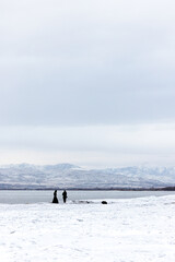 couple on the shore of utah lake in the snow