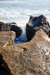 water rushing into beach rocks