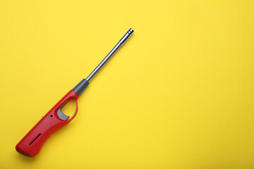 One gas lighter on yellow background, top view. Space for text - obrazy, fototapety, plakaty