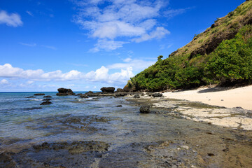 clear beach water under blue sky and green mountain, fiji