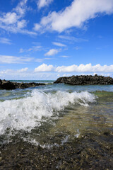 sea wave rolling over rocky beach, fiji