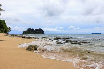 foamy surf with island in background fiji