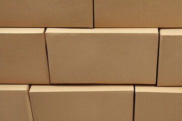 Stack of many closed cardboard boxes as background