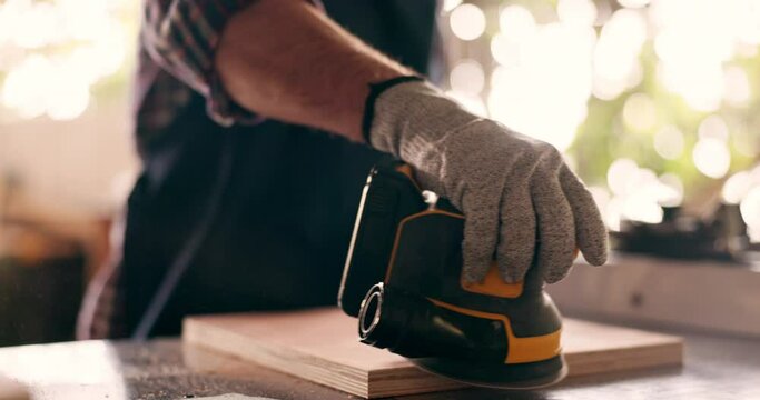 Wood, carpenter and sanding with hands of person in workshop for furniture, manufacturing and renovation. Production, tools and design with closeup of handyman in home garage for board polish