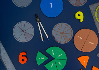 Сolorful math fractions on blue background. interesting math for kids. Education, back to school...