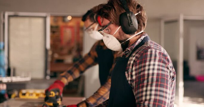 Carpenter, working and people with handyman, planning and tool with manufacturing and maintenance. Garage, craftsman and factory work for remodeling, carpentry or blacksmith project with shop worker