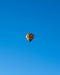 Fototapeta na wymiar beautiful and colorful shot of hot air balloon with basket and blue sky in background