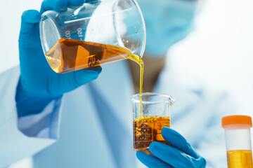 Close-up of laboratory technician conducting rigorous oil test, ensuring product integrity and...