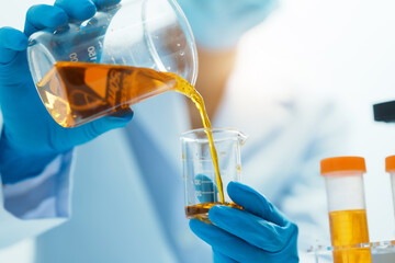 Close-up of laboratory technician conducting rigorous oil test, ensuring product integrity and safety, oil sample for quality control and purity testing, advancing petrochemical knowledge