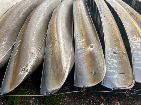 Old aluminum canoes stacked in row, Seattle, WA USA