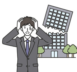 倒産して頭を抱えるスーツを着た男性