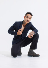 Portrait isolated cutout studio shot Asian vintage classy shirtless sexy mustache neck hand tattoos male fashion model in fashionable blazer suit sitting posing look at camera on white background