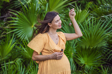 pregnant woman after 40 demonstrating the use of an aroma pendant, combining style and aromatherapy during her pregnancy journey