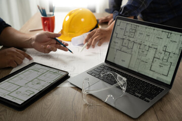 Engineer A construction technology worker checks an engineer using a computer on a construction...