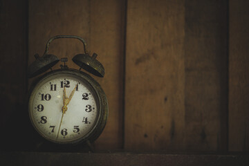 Closeup of an old alarm clock on a background of an old wall.low light images,Noise