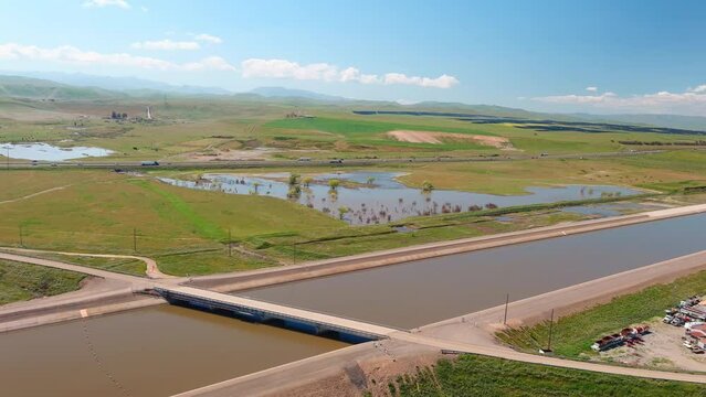 Spring rains in 2023 flooded California's aqueduct and canal system to overflowing - aerial