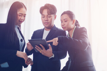 Group of business people and colleagues presenting successful laptop business investment profits after monthly meeting, success concept