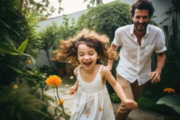 happy father and daughter playing in the garden