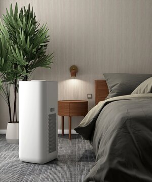 White modern design air purifier, dehumidifier on black carpet floor in beige wall bedroom by cozy bed, palm tree in sunlight from window. Fresh air, healthcare, health technology background 3D