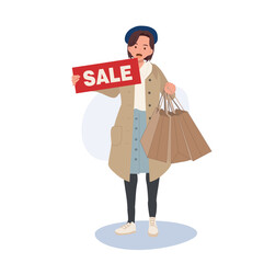 Seasonal Shopping Spree. Autumn Sale. Full-Length Stylish Woman Holding Sale Sign with Shopping Bags. Happy Shopper with Autumn Discounts