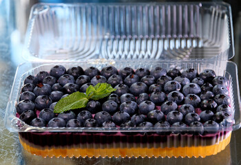 Fruit jelly dessert or panna cotta with fresh strawberries and blueberries, on white background. High quality 4k footage