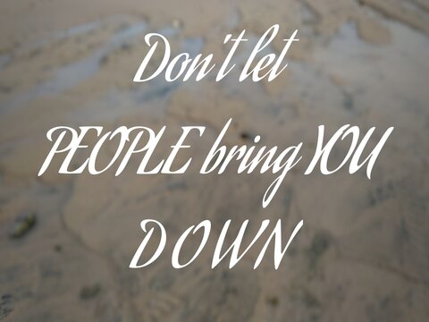 Motivational quote "Don't let people bring you down" on nature background. Wet watery beach sand.
