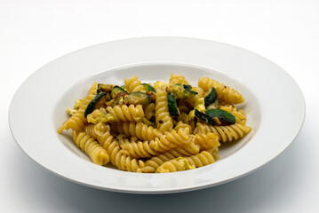 Italian Carbonara di zucchine in a white dish. Zucchini Vegetarian Carbonara