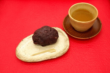Ohagi and green tea (red Japanese paper background)