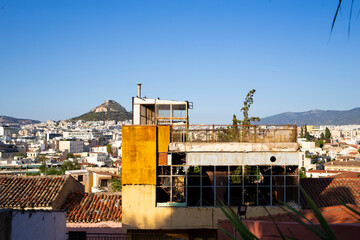 Fototapeta premium Old ruined building in top of Plaka district as seen in Athens skyline