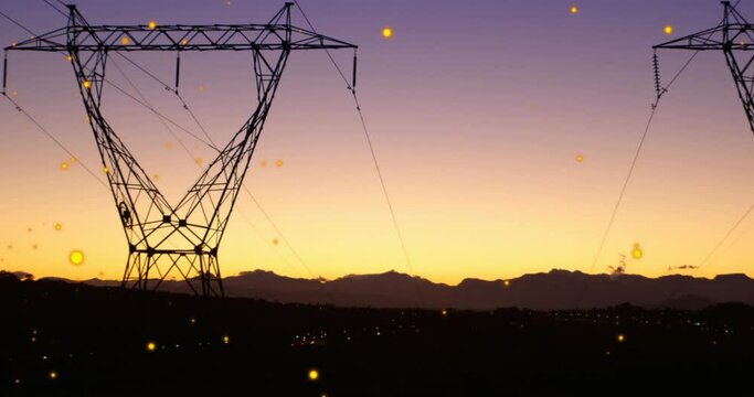 Animation of lens flares over transmission tower against silhouette of mountains