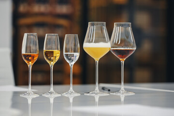 Blind tasting, various full glasses with different alcoholic beverages. Wine school, sommelier degustation.